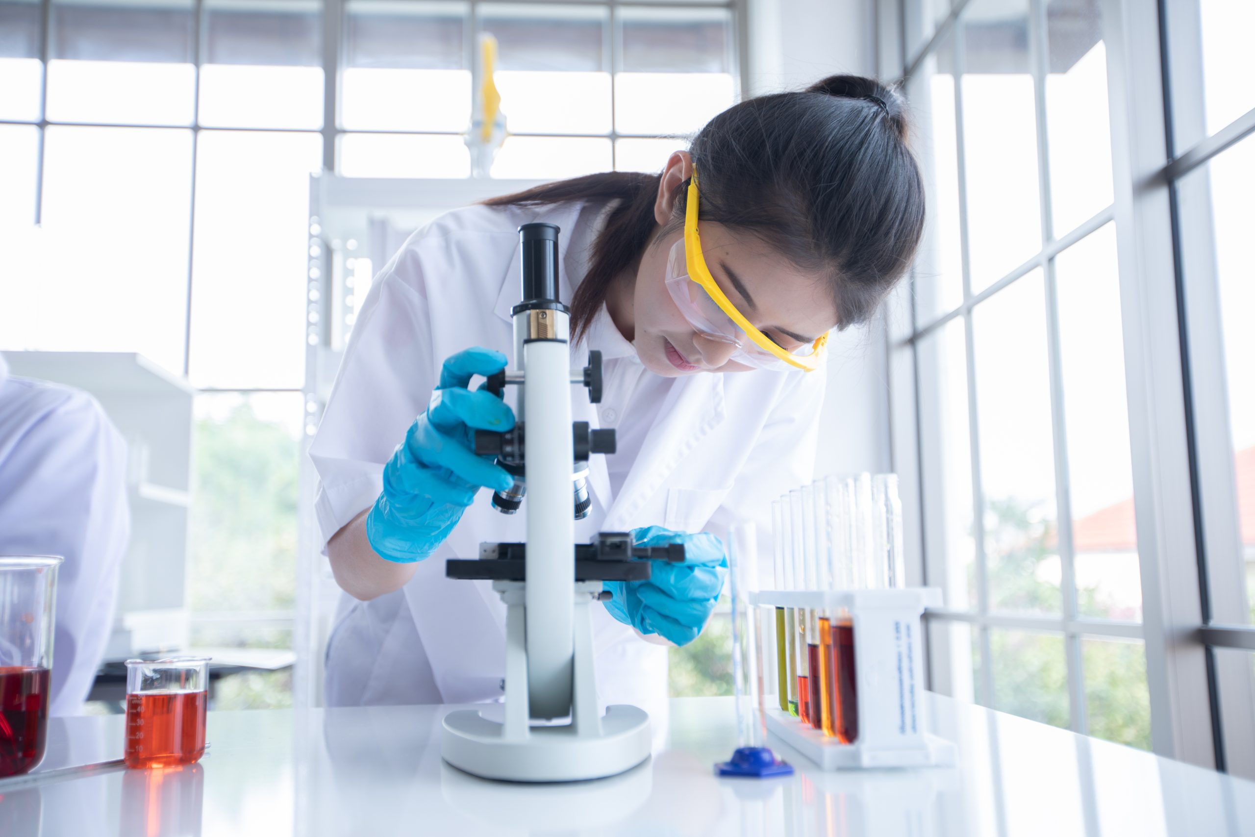 medical research and scientists are working with a microscope an